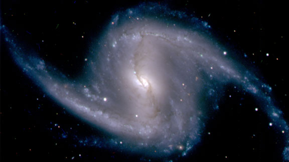 Zoomed-in image from the Dark Energy Camera of the barred spiral galaxy NGC 1365, in the Fornax cluster of galaxies, which lies about 60 million light years from Earth.