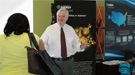 Associate Director of Science for Nuclear Physics, Tim Hallman, speaks to an open-house guest at the Office of Science booth