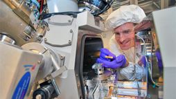 A scientist working with a focused-ion beam instrument.