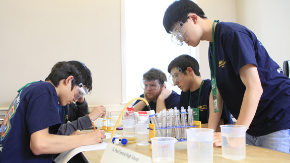 A group of students gathered around a table.