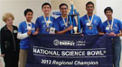 A group of students and teachers holding a banner that reads "National Science Bowl 2013 Regional Champion".