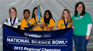A group of students and teachers holding a banner that reads "National Science Bowl 2013 Regional Champion".