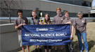A group of students and teachers holding a banner that reads "National Science Bowl 2013 Regional Champion".