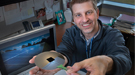 Chuck Black of the Center for Functional Nanomaterials displays a nanotextured square of silicon on top of an ordinary silicon wafer.