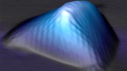 In this scanning tunneling microscopy image of a graphene nanobubble, the graphene crystal is distorted and stretched along three main axes. 