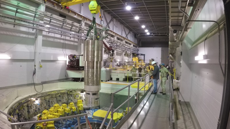 A heavy overhead crane is used to lower the 64,000-pound inner reflector plug into position, right in the heart of the Spallation Neutron Source. (image credit: ORNL/Genevieve Martin)
