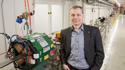 Director Sergei Nagaitsev stands in front of an accelerator beamline under construction at the Fermilab Accelerator Complex. 