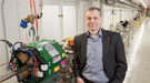 Director Sergei Nagaitsev stands in front of an accelerator beamline under construction at the Fermilab Accelerator Complex. 