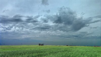 Land and atmosphere—as in this LBNL photo titled “Sky and Field,” by Roy Kaltschmidt—and how they consequentially interact are the chief current research interest of atmospheric scientist Ian Williams.