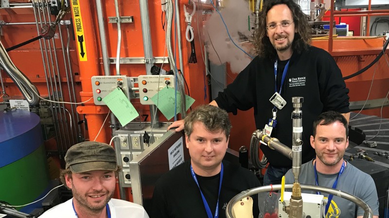 Standing at the WAND2 instrument, researchers (from left to right) Michael Heere and Yaroslav Filinchuk with ORNL beamline scientists Matthias Frontzek and Simon Kimber. (Image credit: ORNL/Jeremy Rumsey)