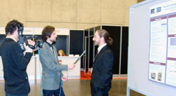 intern speaks with a journalist about his research