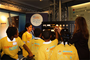 Young students looking at the light power created by a classmate riding the display bike