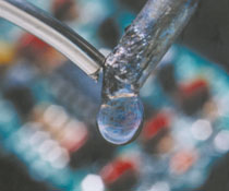 A soldering iron touching the end of a wire producing a droplet
