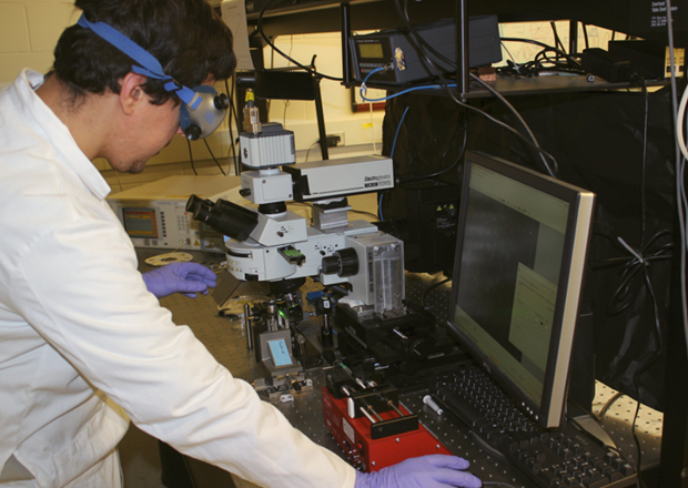 Scientist in the lab surrounded by lab equipment