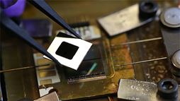 A nanophotonic solar thermophotovoltaic device composed of an array of multi‑walled carbon nanotubes as the absorber, a one‑dimensional silicon/silicon dioxide photonic crystal as the emitter, and a 0.55 eV photovoltaic cell.